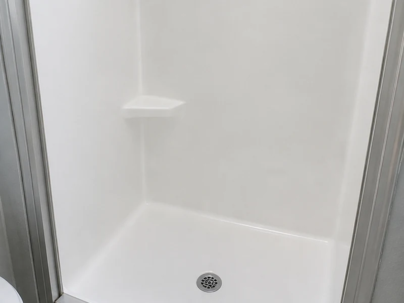 Refinished white fiberglass shower stall in a turned Cherryland rental unit, Hayward, CA
